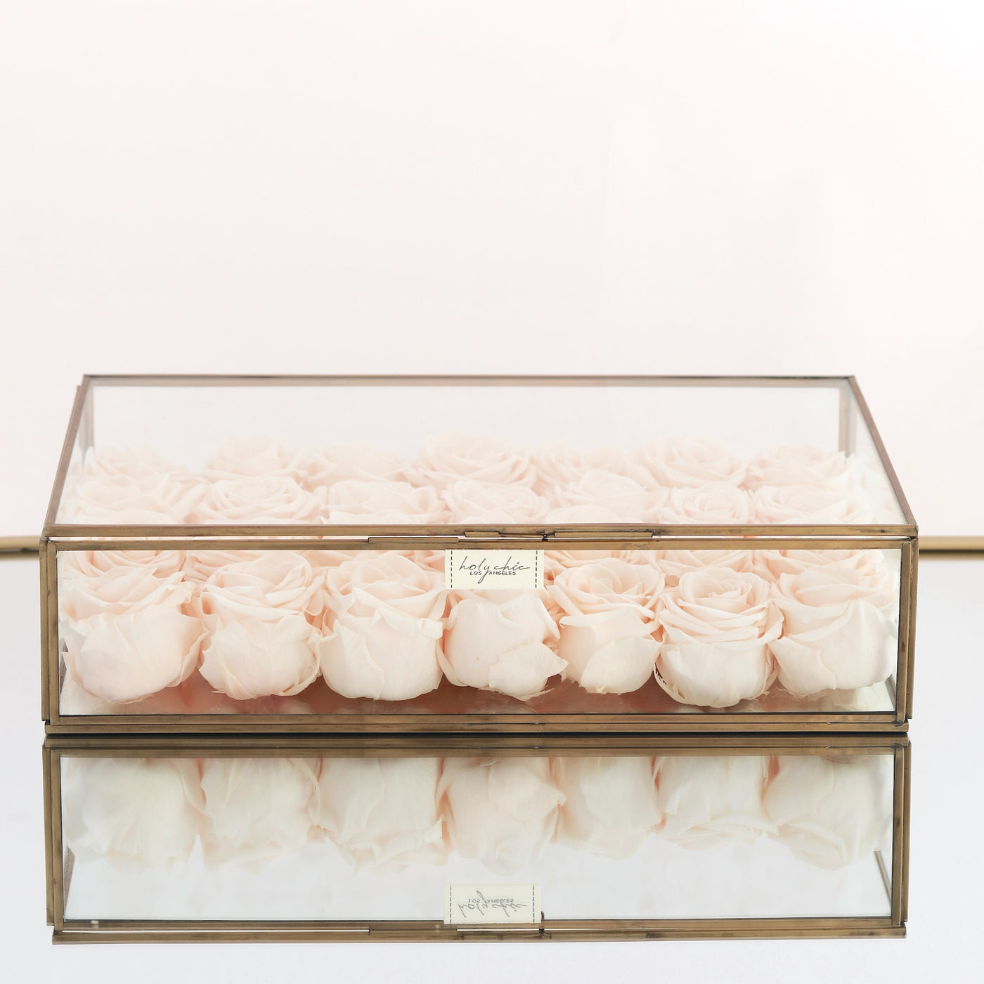 Forever roses in a large clear jewelry glass box