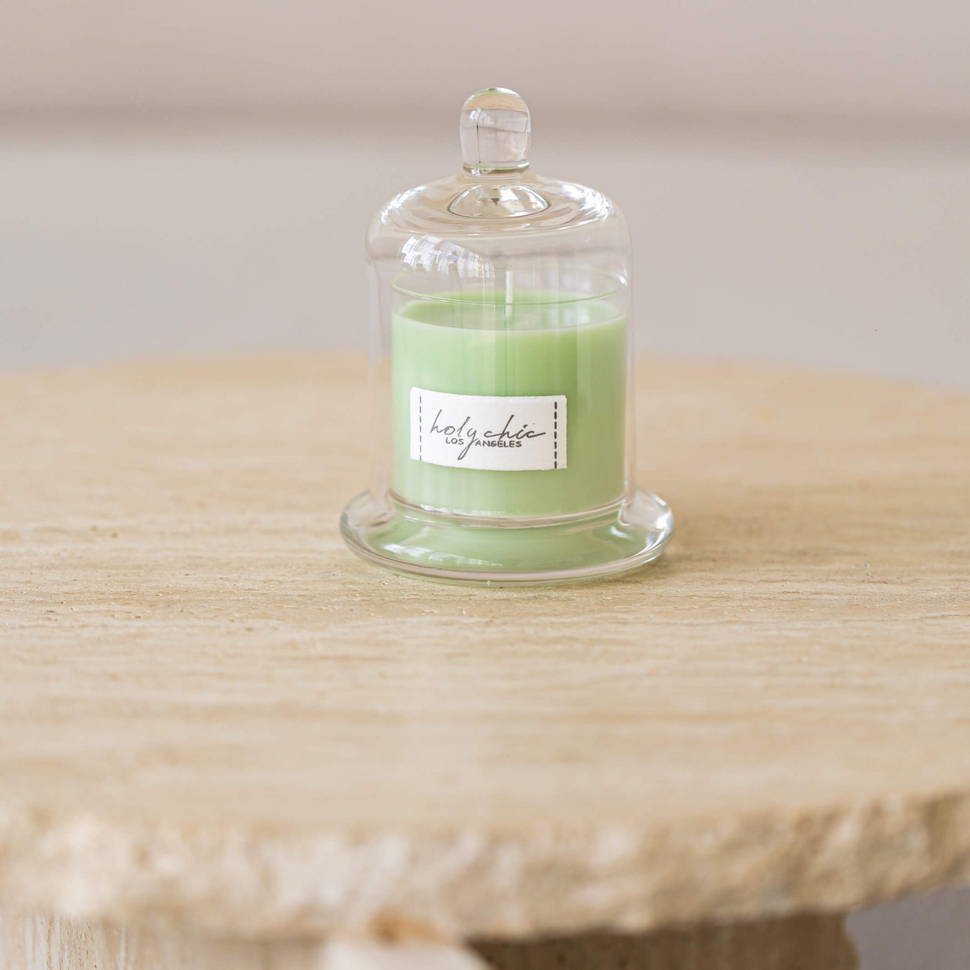 Pale greeen mint scented candle in a glass cup with a cloche in smal size