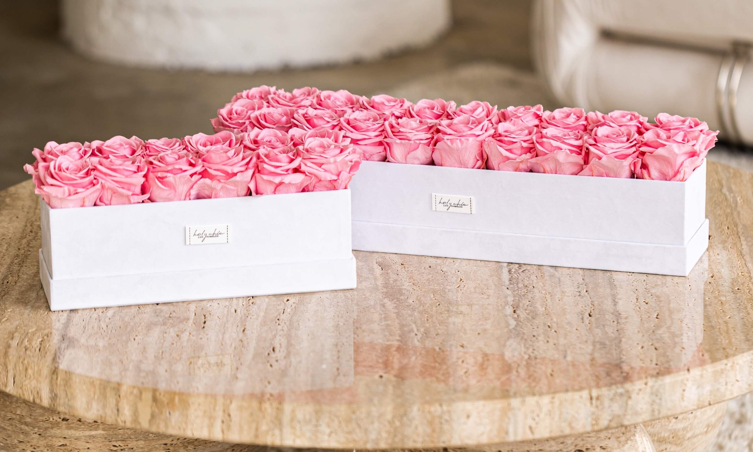 Pink forever roses in rectangular centerpiece shaped white velvet boxes