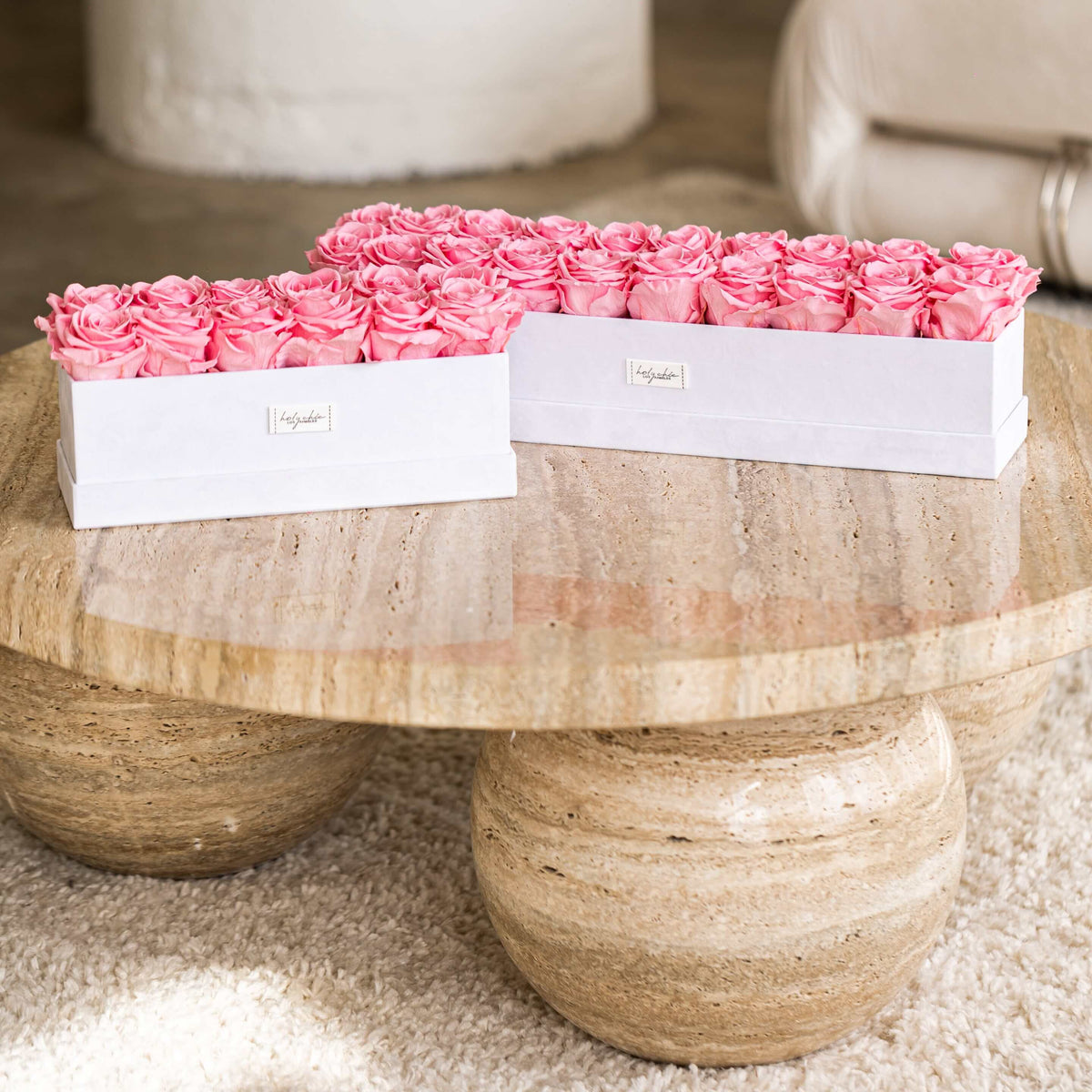 Pink forever roses in rectangular centerpiece shaped white velvet boxes