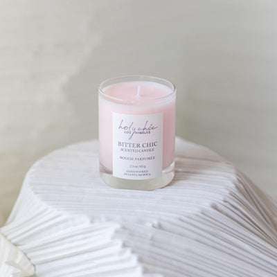 A scented votive candle in a light pink color