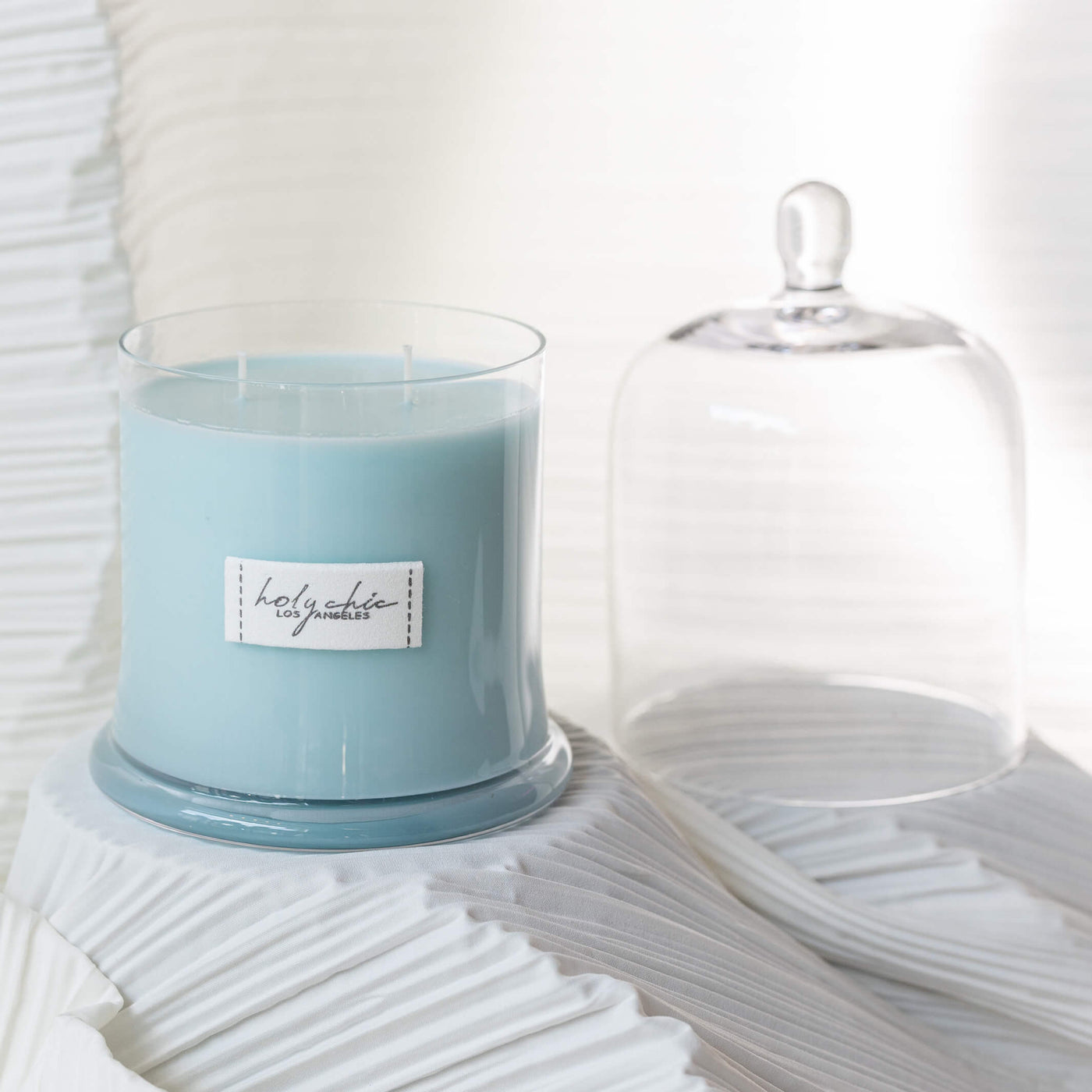 A scented candle in a light blue color