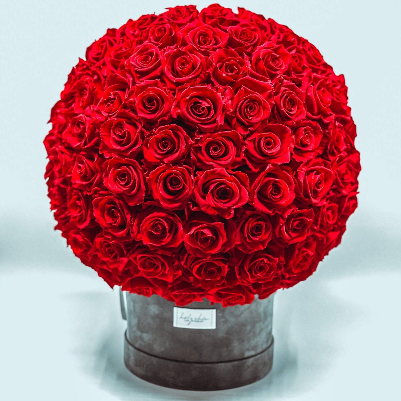 Forever roses set as a dome in a large round suede box 