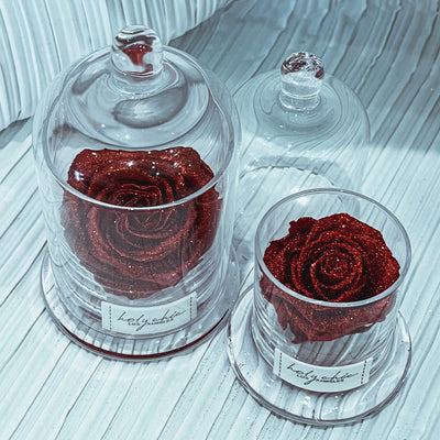 Sparkling forever rose in a clear glass dome