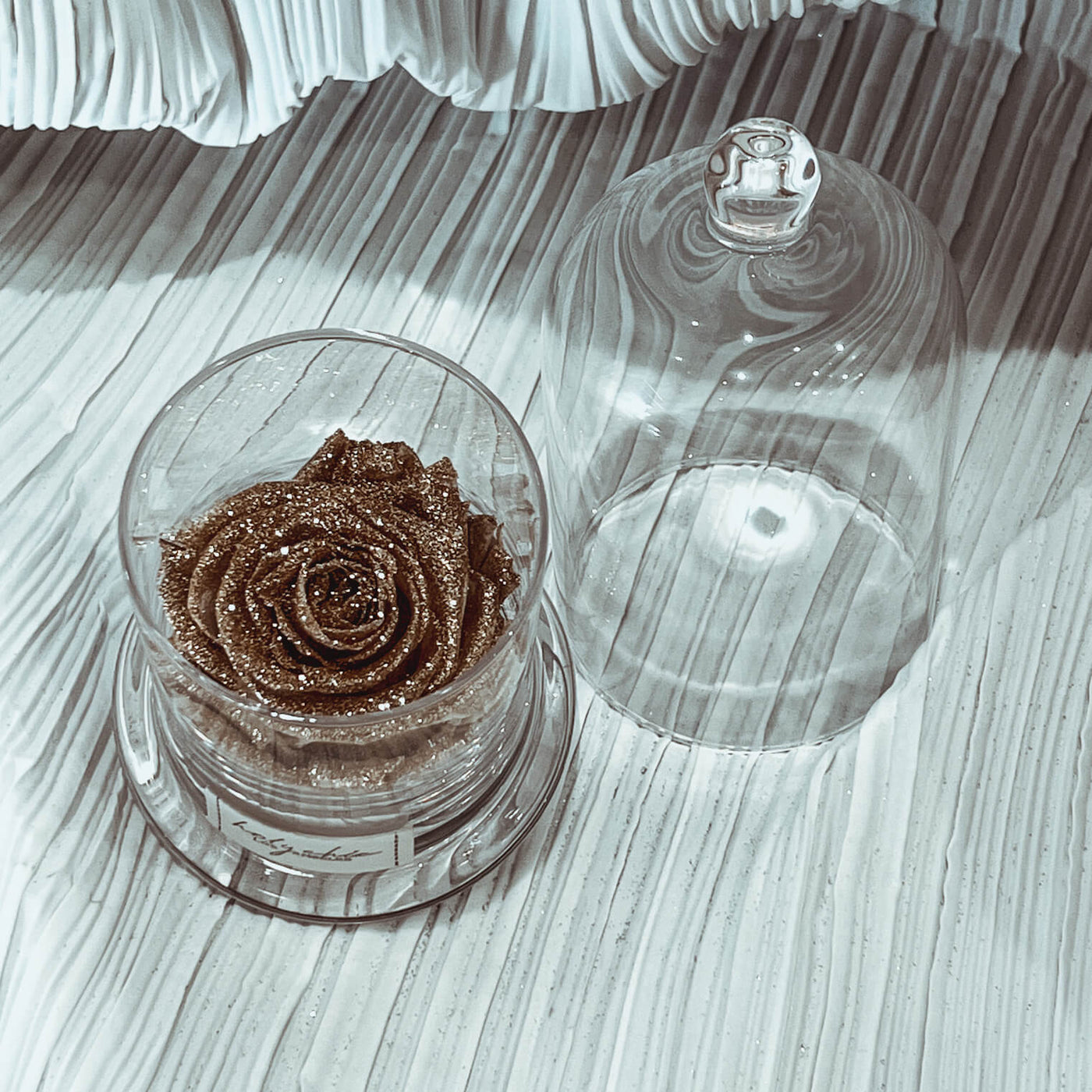 Sparkling forever rose in a clear glass dome