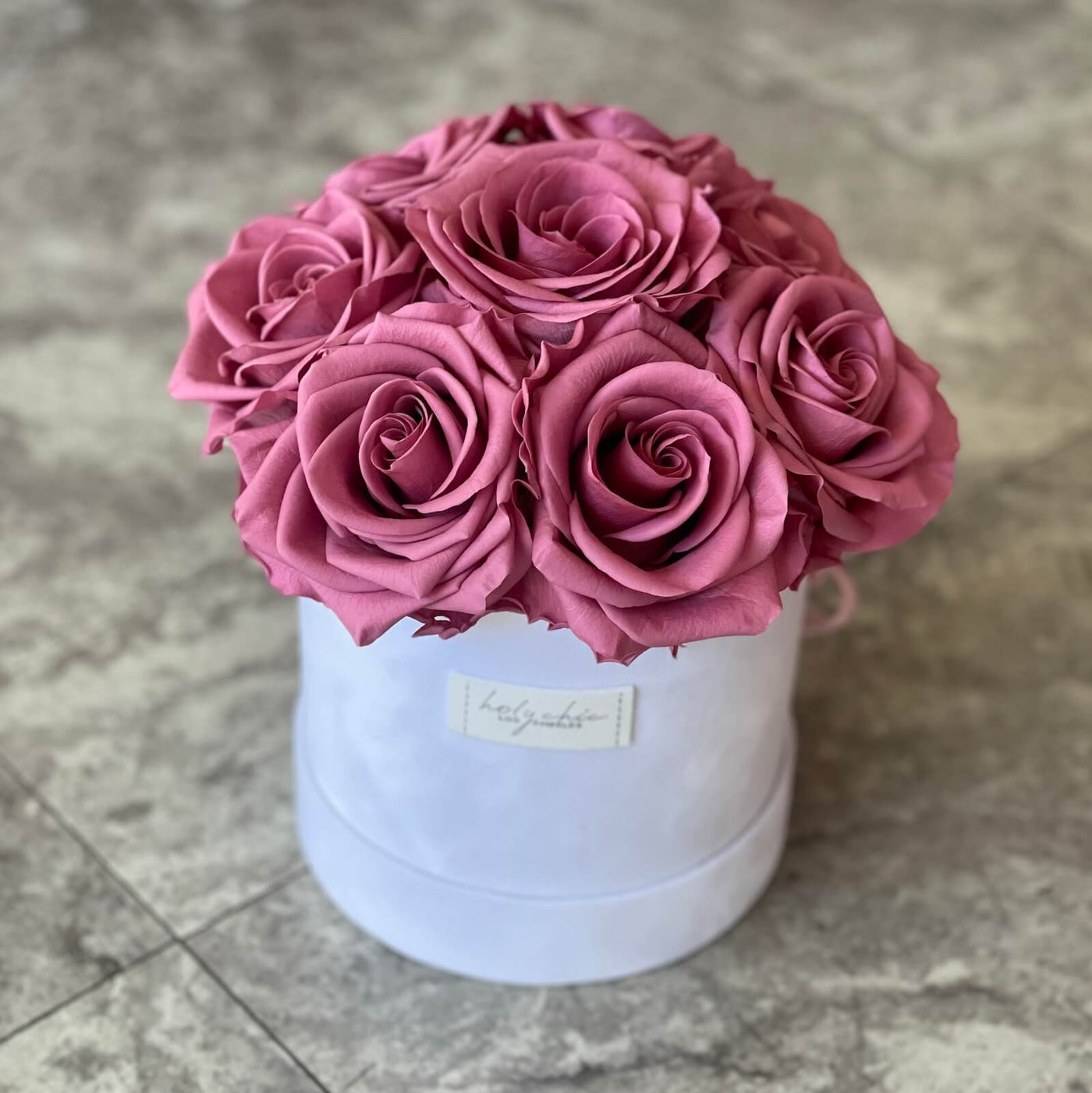 Forever roses set in a round suede hat box