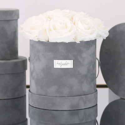 Forever roses set in a medium size round suede box