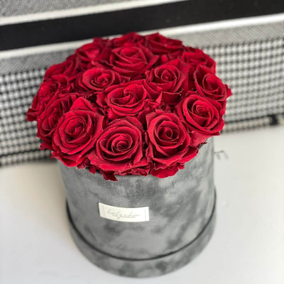 Forever roses set in a medium size round suede box