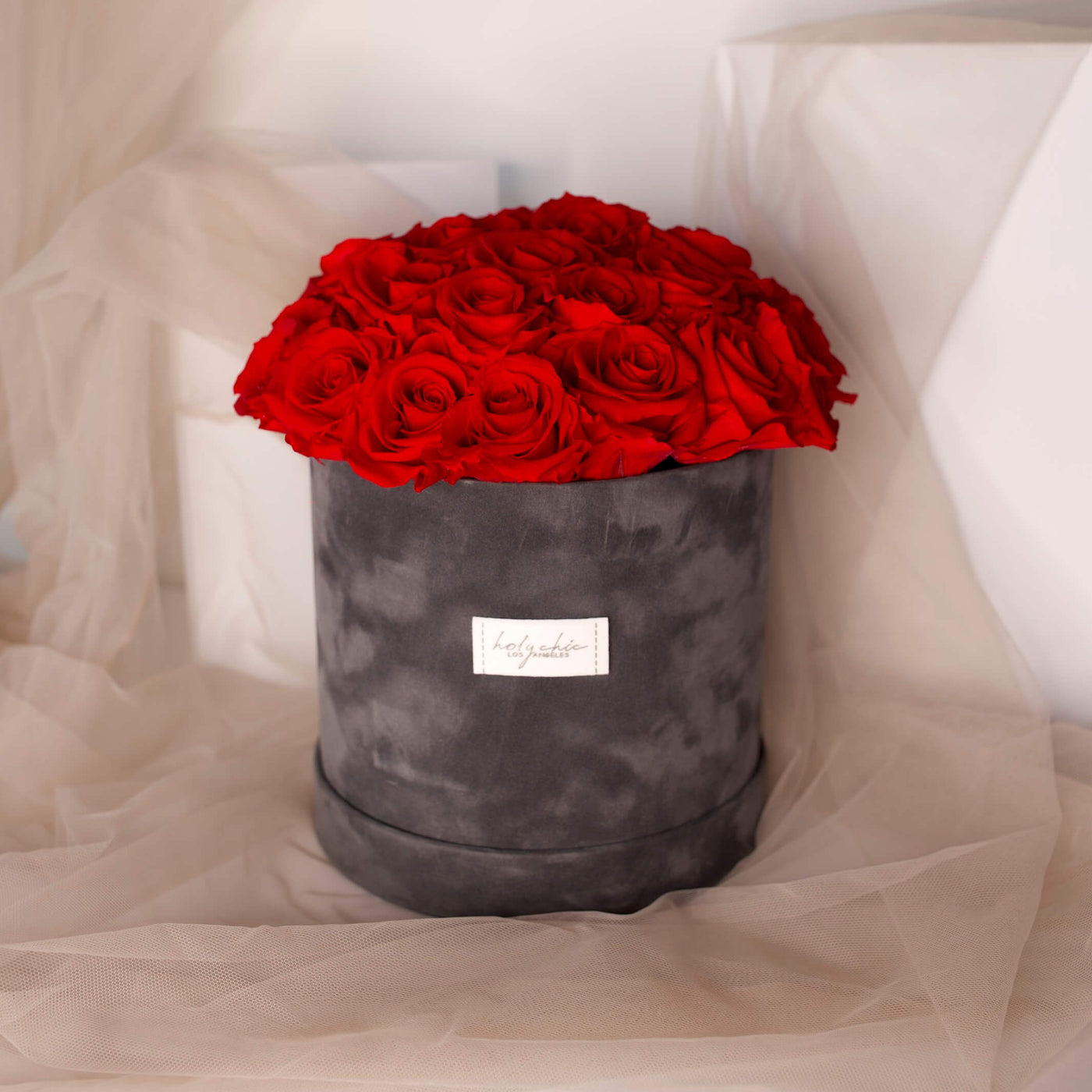 Red forever roses in a dark grey velvet box- Holy Chic Los Angeles