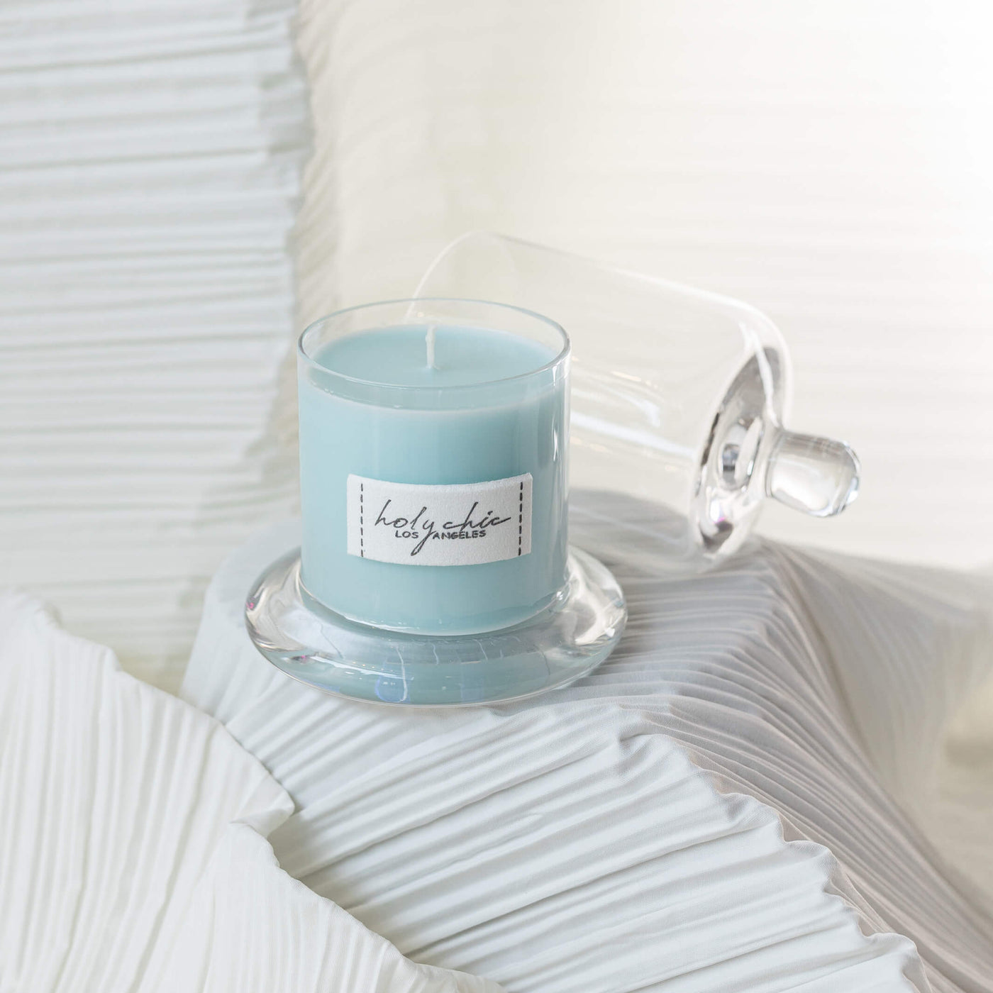 A scented candle in a light blue color