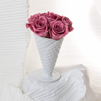 Forever roses arranged in a white ceramic vase