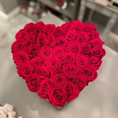 Forever roses arranged in a large heart-shaped suede box