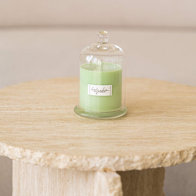 Pale greeen mint scented candle in a glass cup with a cloche in medium size