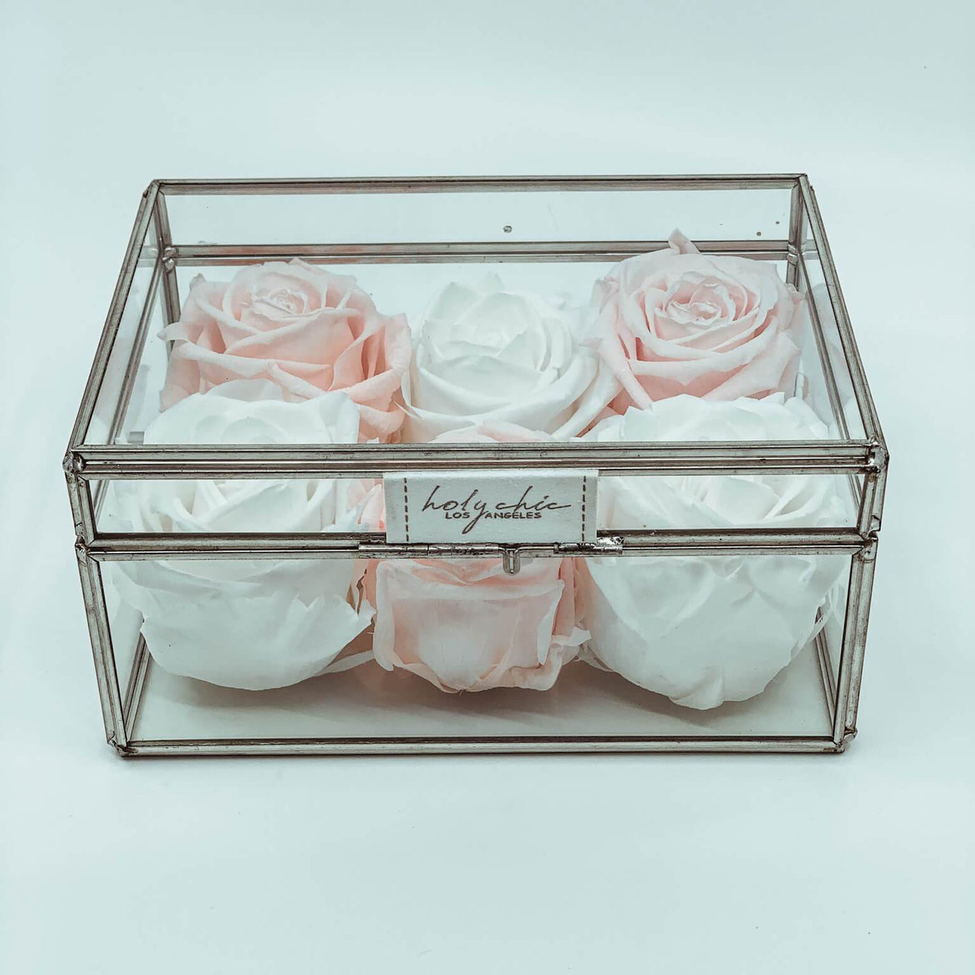 Forever roses set in a small clear glass jewelry box