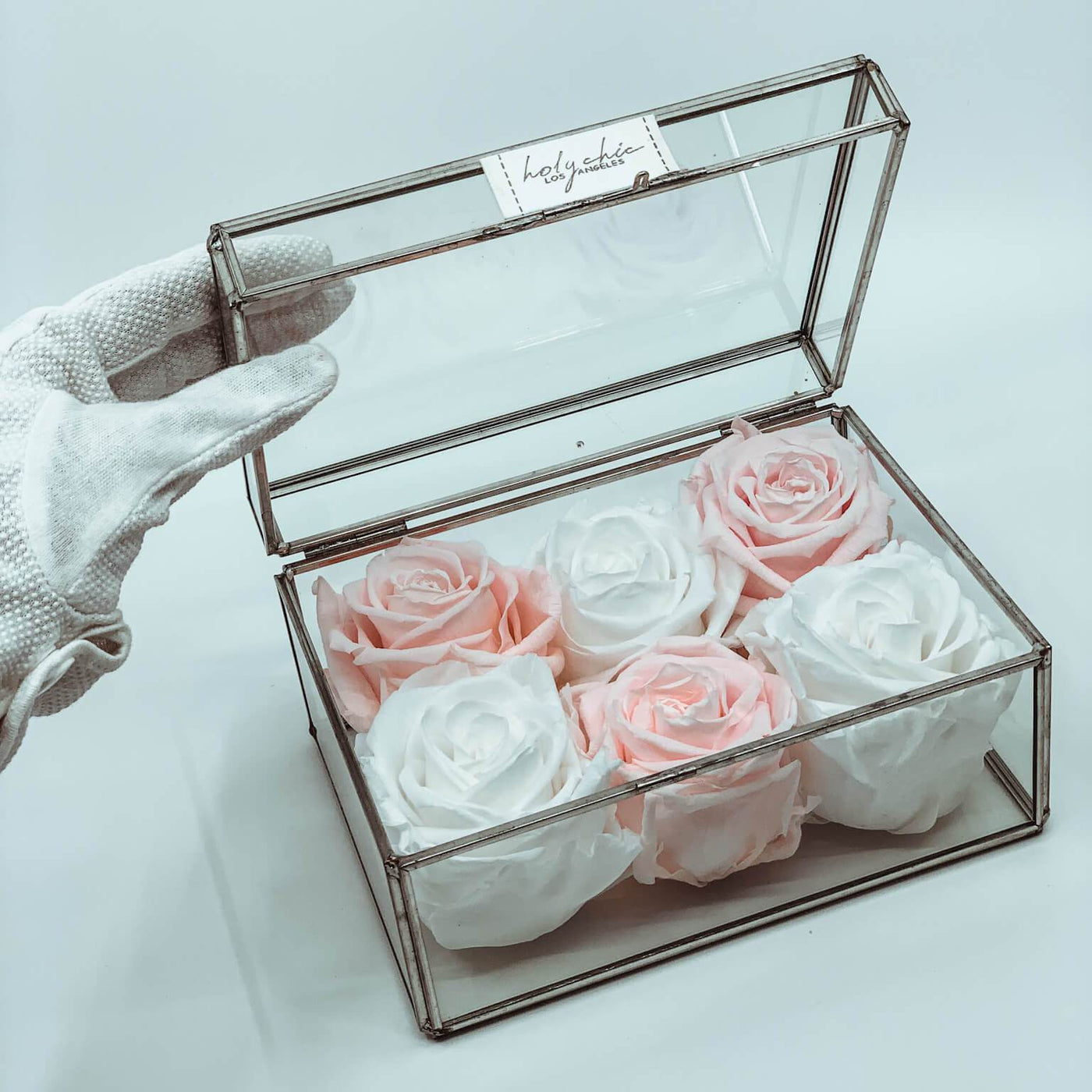 Forever roses set in a small clear glass jewelry box